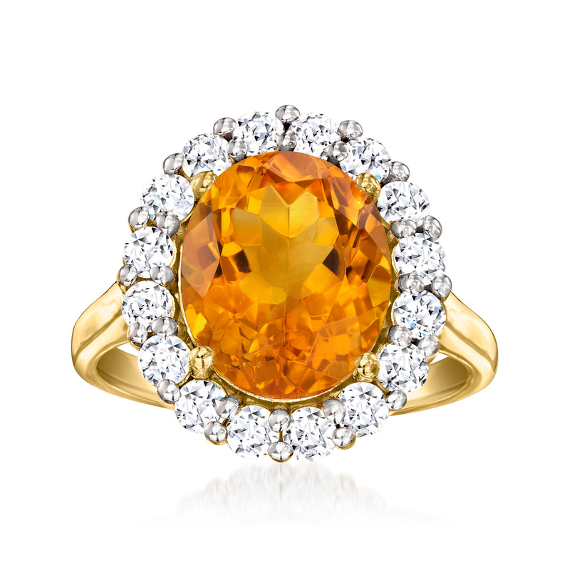 Gold ring with oval orange citrine center and diamond halo cluster around it