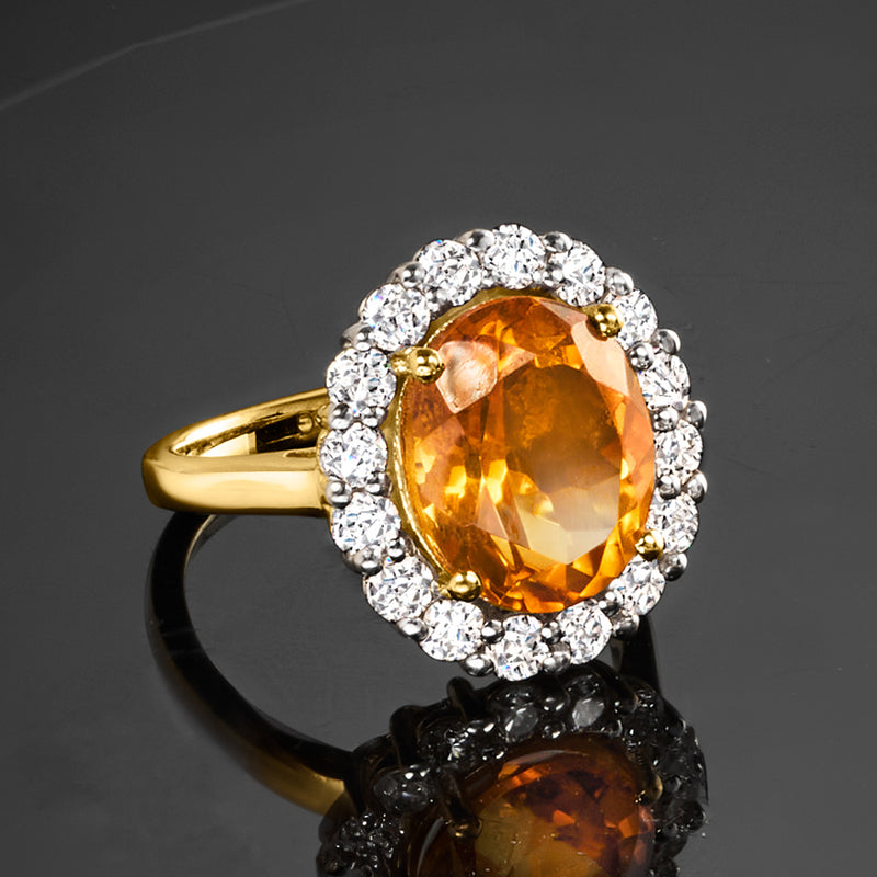 Citrine gemstone halo ring in gold with oval orange center and round diamond surround