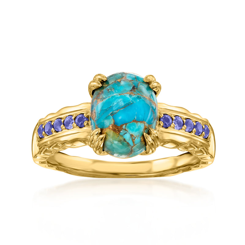 Gold-tone ring with oval turquoise center stone and purple gemstone side accents