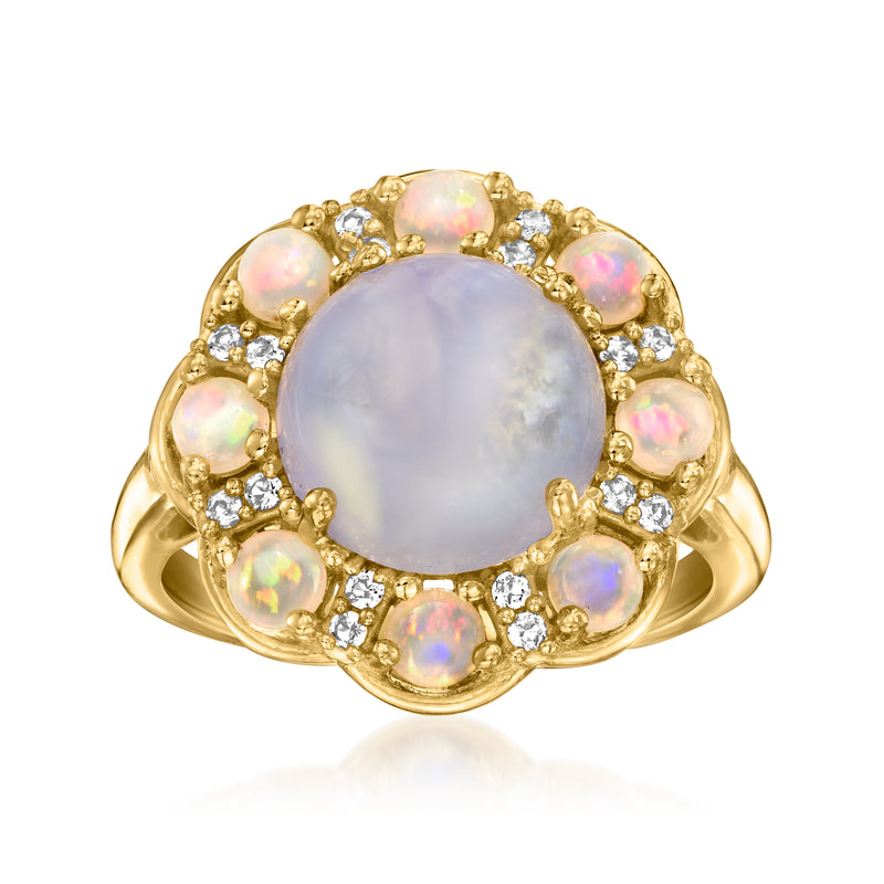 Gold ring with oval opal-like center, halo of clear stones and iridescent side accents