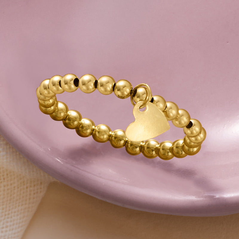 14kt yellow gold bead stretch ring with flat heart charm on round beads
