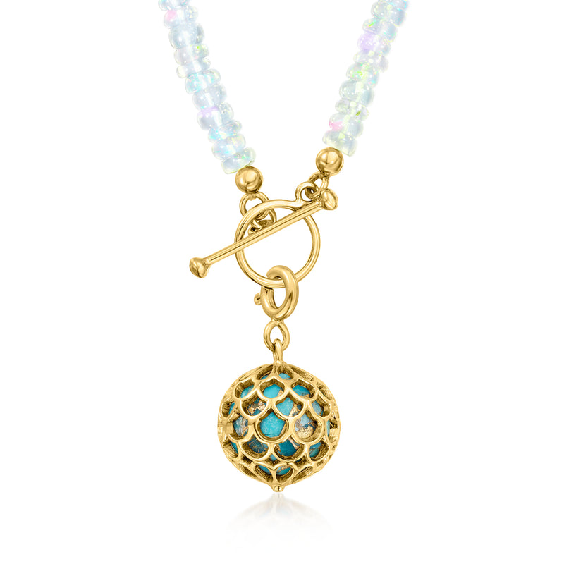 Gold charm with turquoise scales pattern and dangling hoop detail.