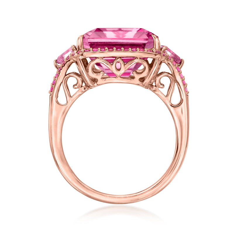Rose gold openwork band ring with prong-set pink gemstone center and sapphire trim