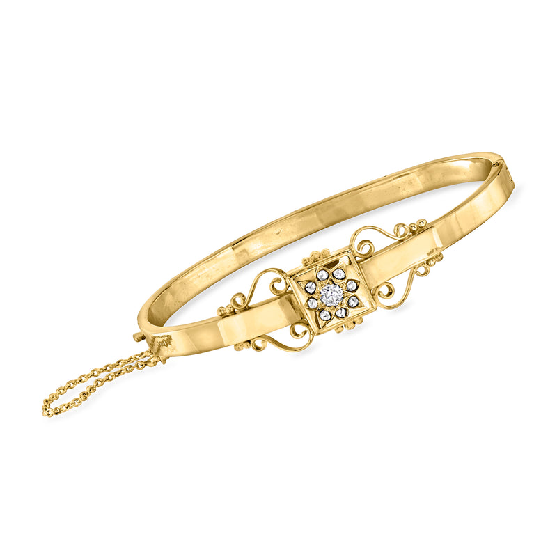 Vintage yellow gold bangle bracelet with diamond scroll motif and clasp chain