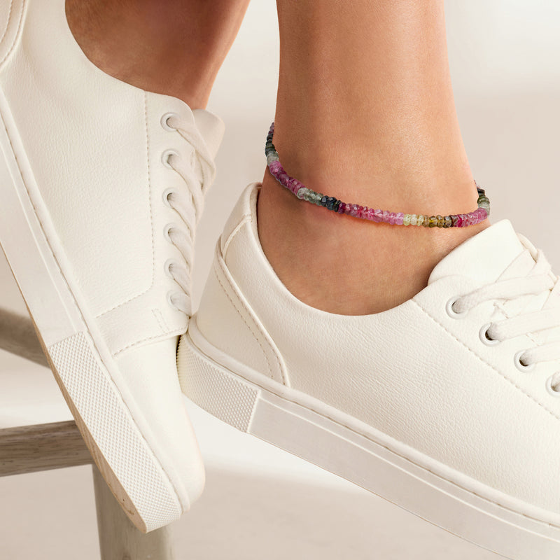 Multicolored tourmaline bead anklet on ankle with small gold-tone clasp