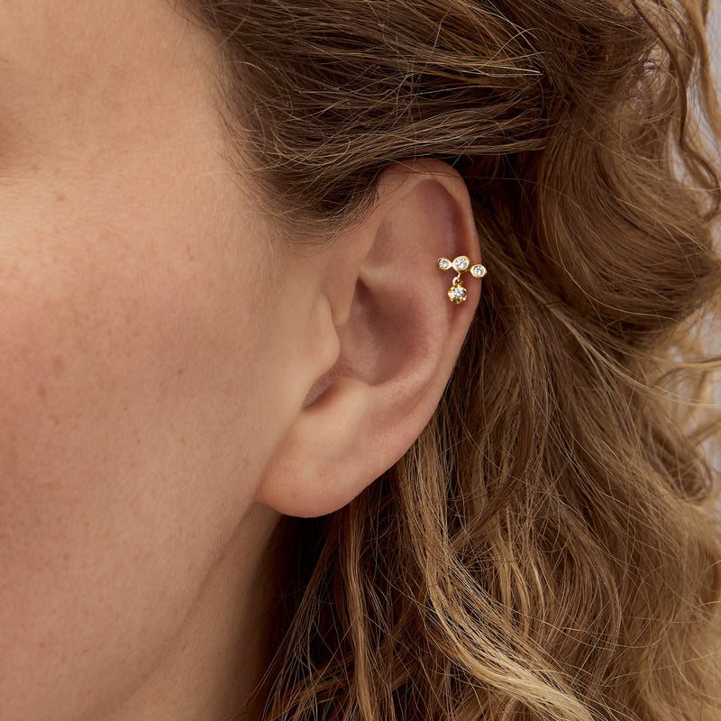 14kt yellow gold diamond stud earring with three stones and dangling charm
