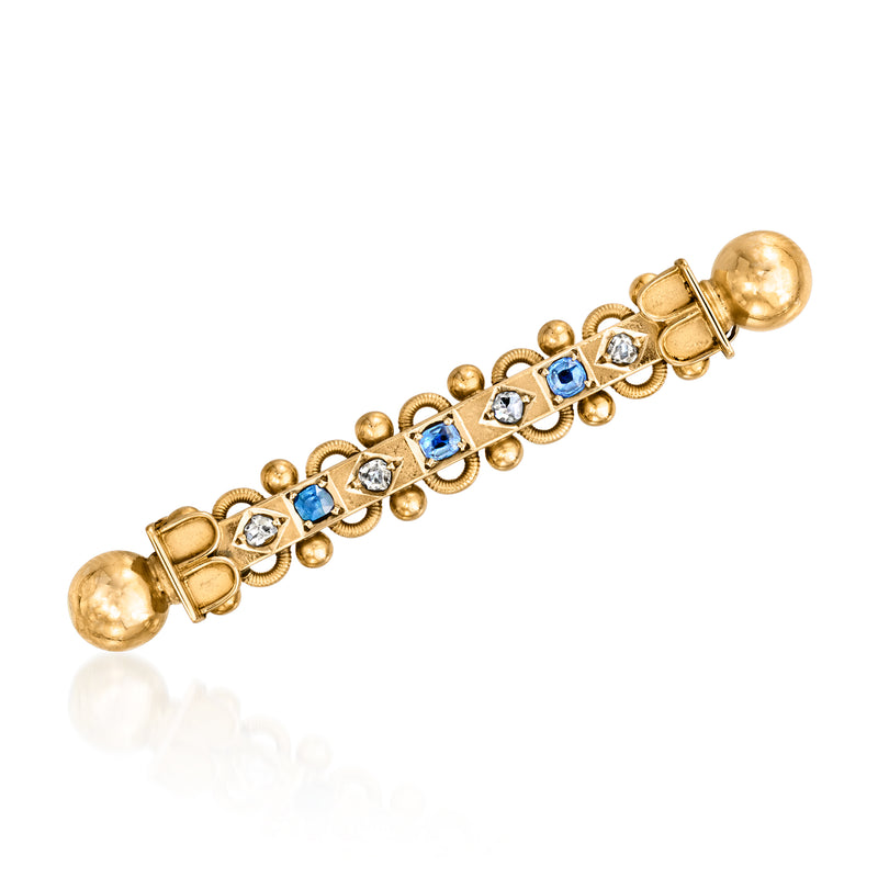 Vintage bar pin in 20kt yellow gold with blue sapphire and diamond accents