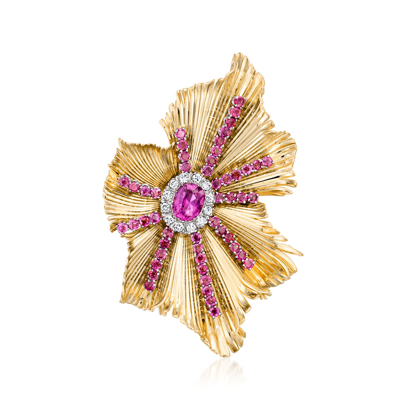 Yellow gold flower pin with oval pink center and pink gemstone accents, diamond-like halo