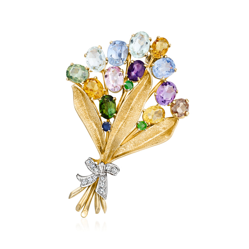 Vintage gold bouquet pin with multicolor gemstones and diamond bow accents.