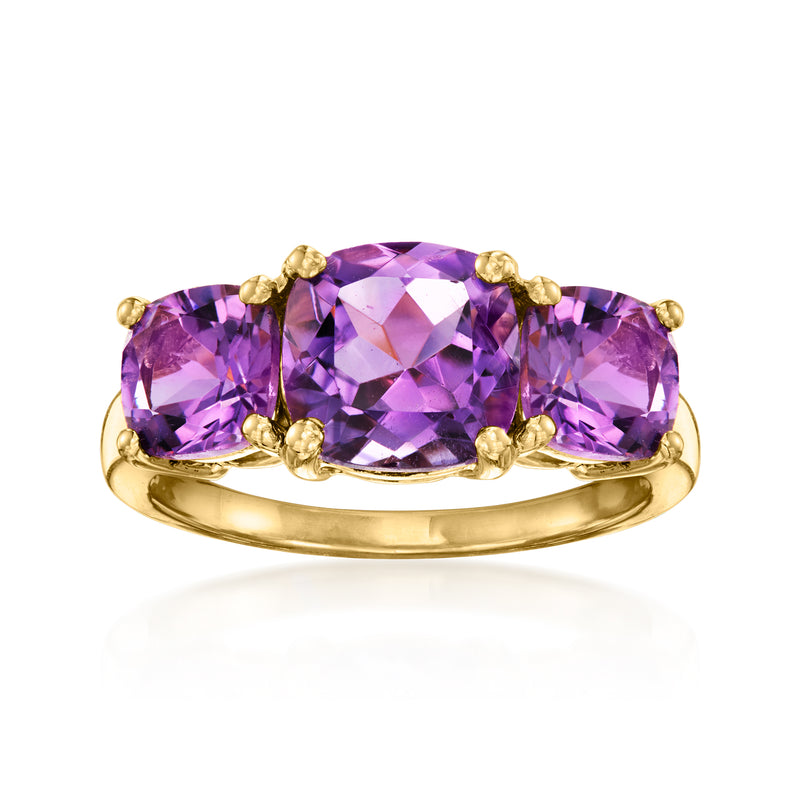 Amethyst three-stone ring with oval purple gemstones in gold-tone band