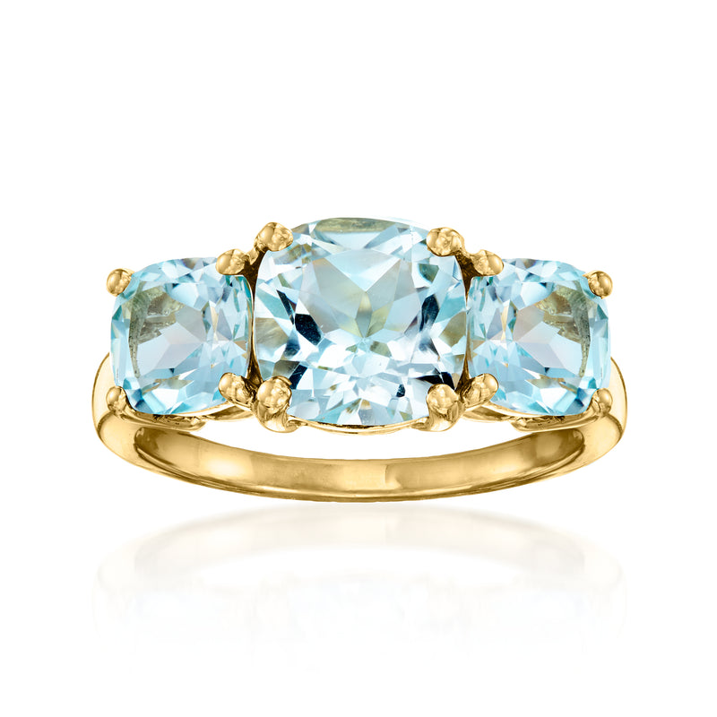 Sky blue topaz three-stone ring with oval stones in gold over sterling setting