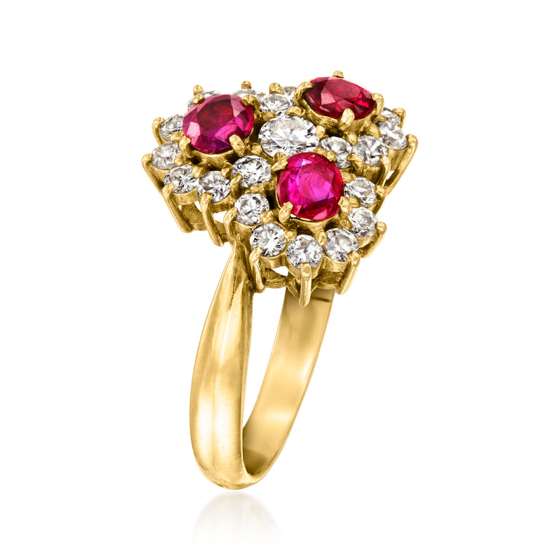 Gold cluster ring with three magenta rubies and surrounding round white diamonds