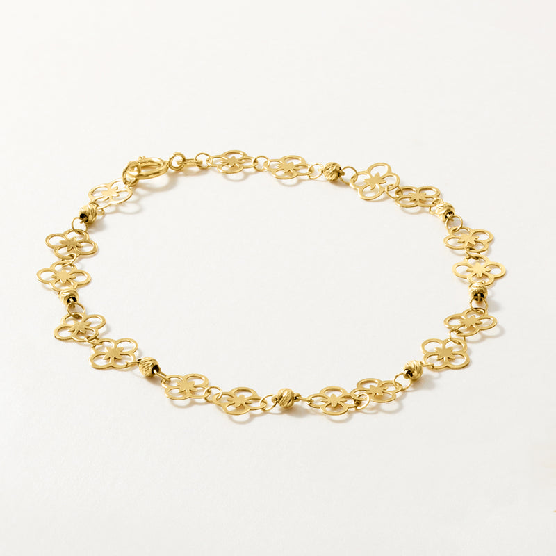 10kt yellow gold floral bracelet with repeating four-petal clover motifs