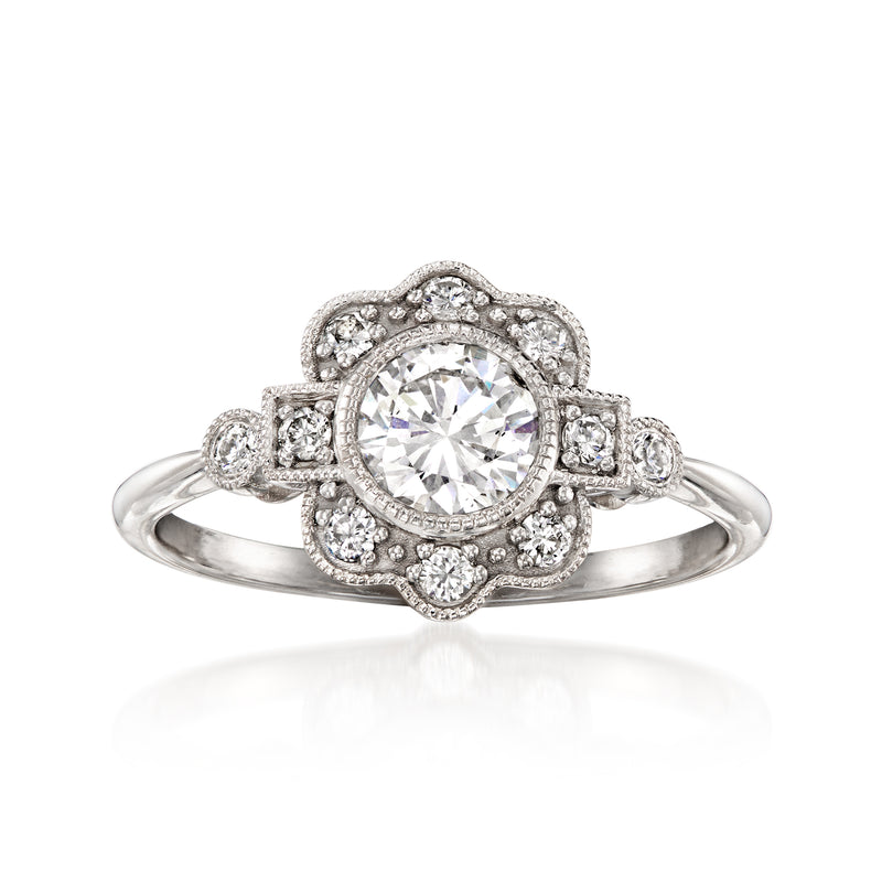 Platinum vintage diamond cluster ring with round center stone and halo, side diamonds