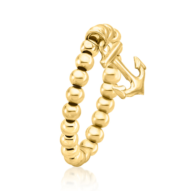 Yellow gold bead stretch ring with anchor charm, close-up angled view