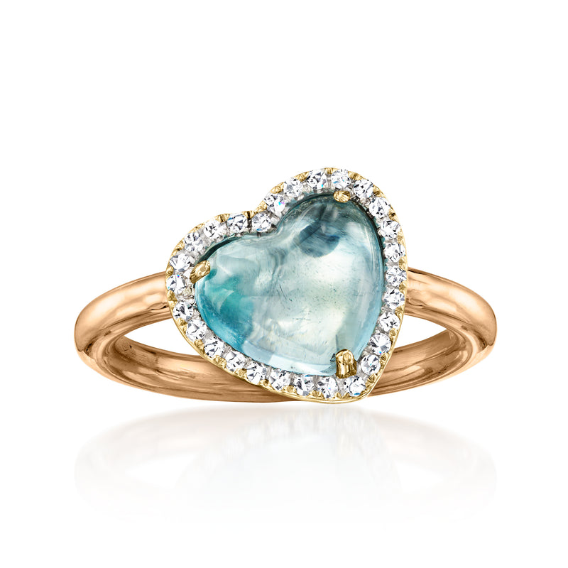 Heart-shaped sky blue gemstone ring with diamond halo, tri-colored 18kt gold.