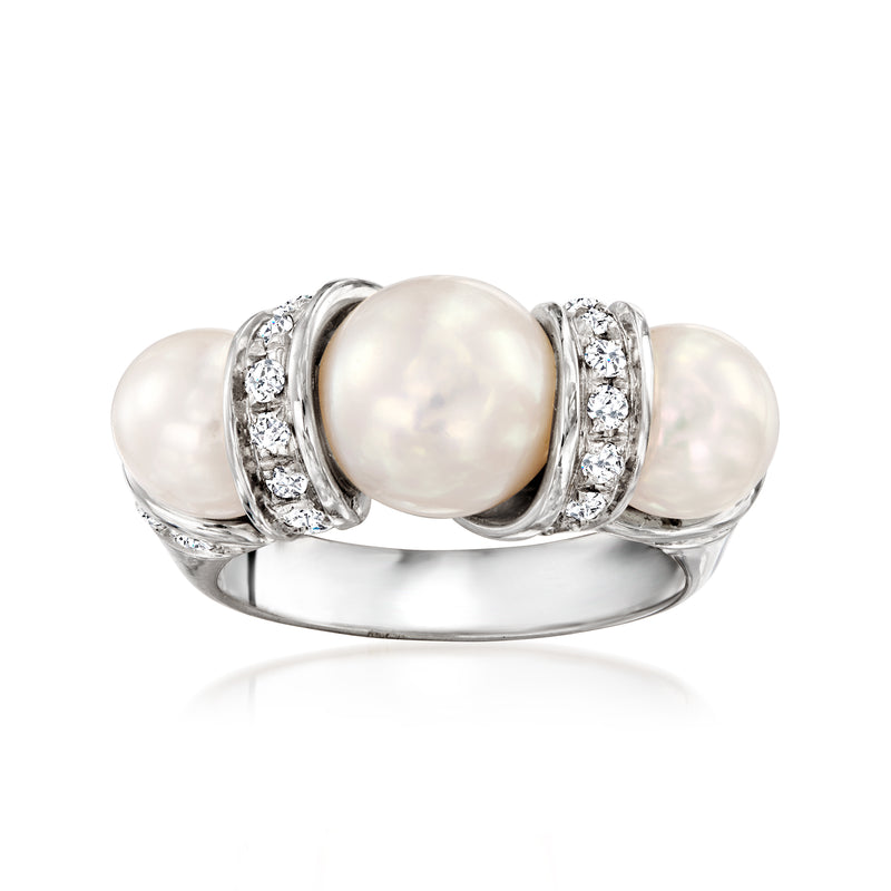 Cultured pearl and diamond ring in polished white gold, round central pearl