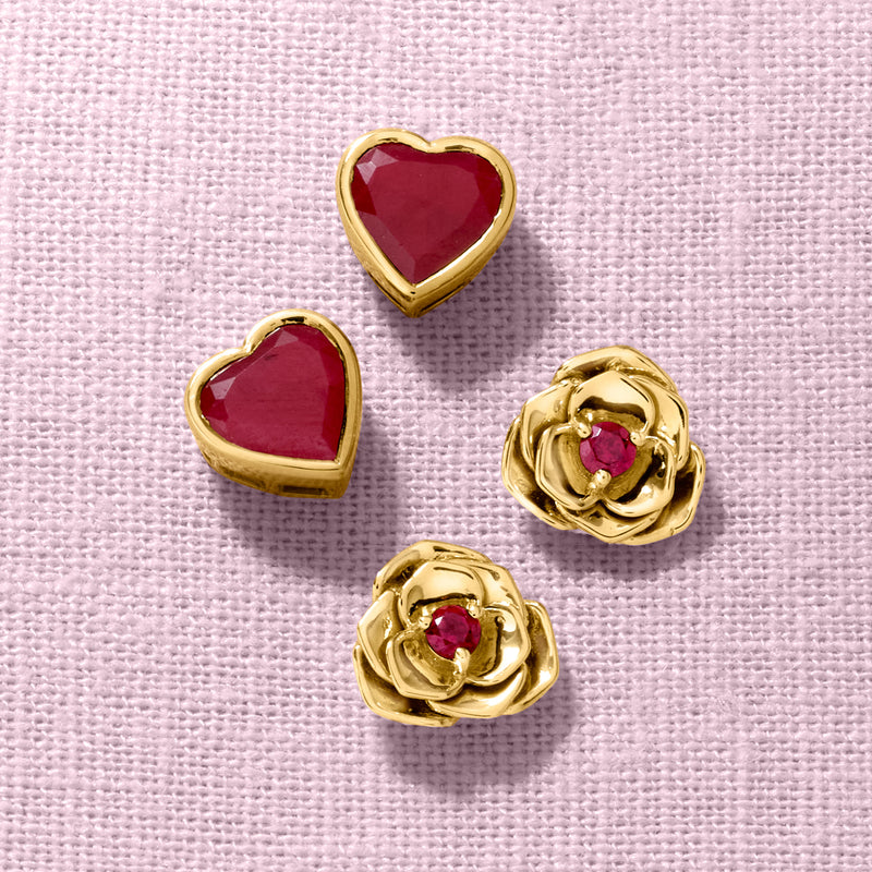 Gold-tone heart and flower stud earrings with red gemstones, set view.