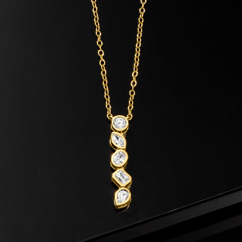 Gold linear pendant necklace with five bezel-set diamonds, including one baguette