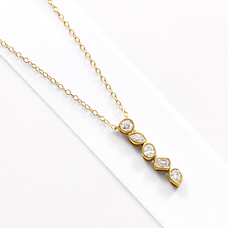 Linear lab-grown diamond necklace with five bezel-set stones on gold link chain