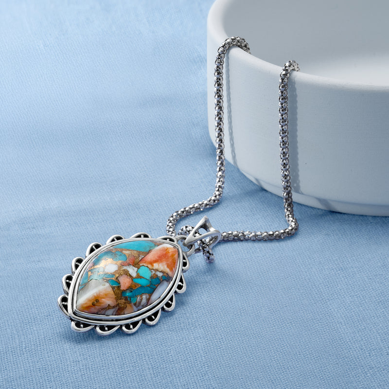 Sterling silver pendant necklace with turquoise marquise gemstone on chain, side view