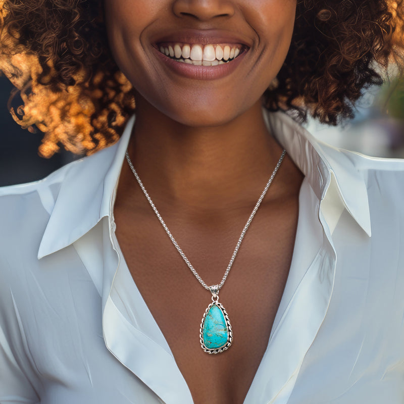 Sterling silver teardrop turquoise pendant necklace on model, long chain and teardrop charm