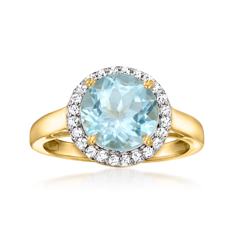 Gold oval sky blue topaz ring with diamond halo and round accent stones, open band