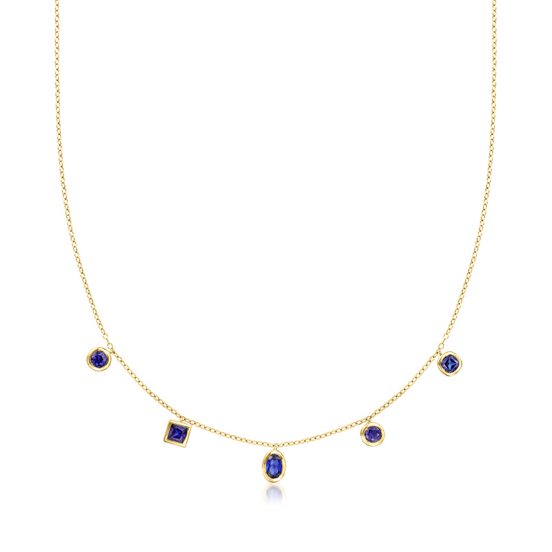 Gold sapphire necklace with round and square blue stones, delicate chain.