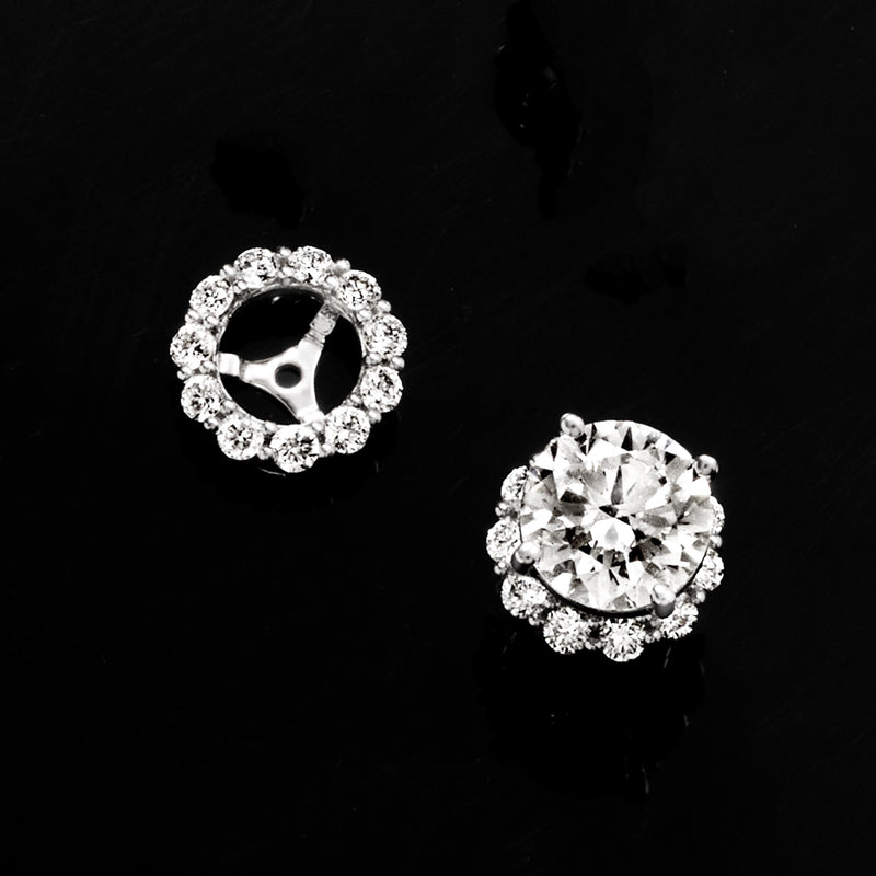 Diamond earring jacket with circular halo of stones on a 14kt white gold mount