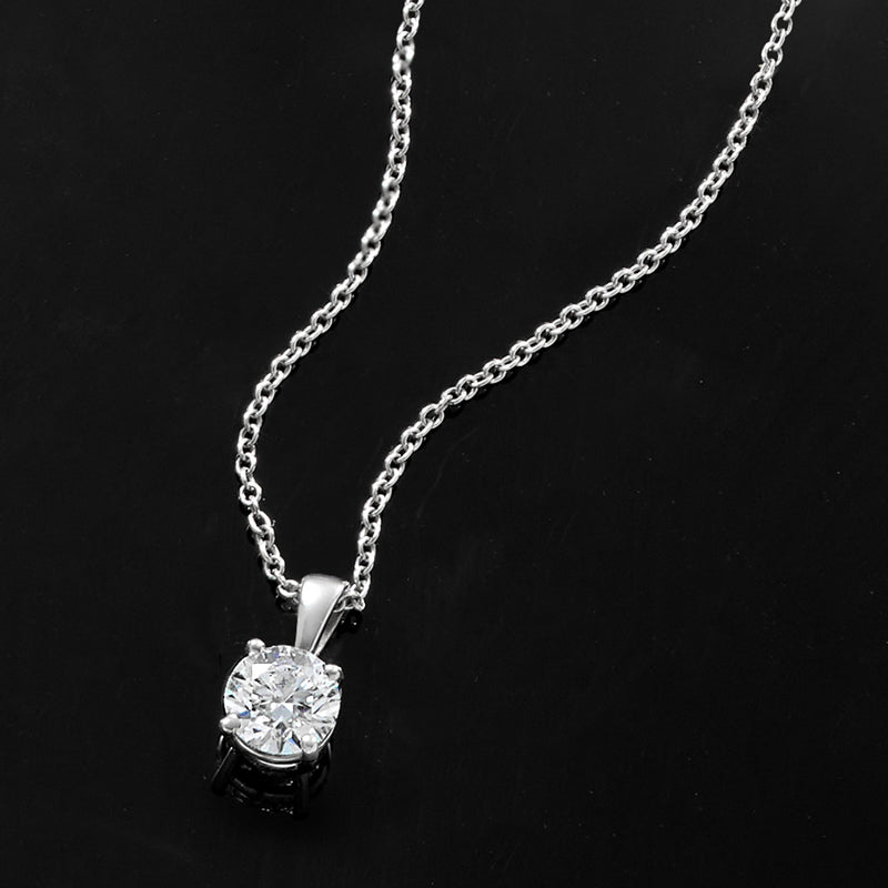 Platinum solitaire diamond necklace close-up of round diamond pendant and chain