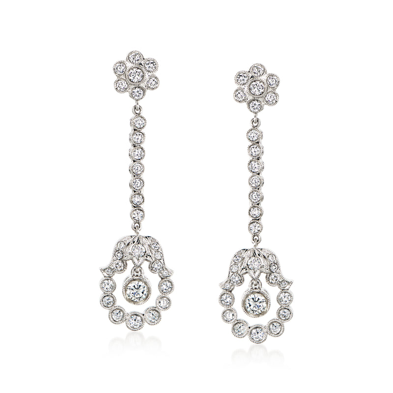 Platinum diamond drop earrings with flower top and dangling oval center stones