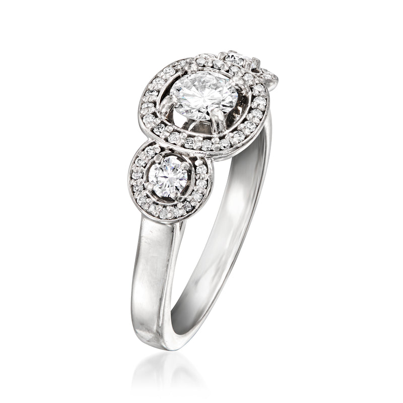 Platinum diamond ring with round center stone halo and lower round stone cluster