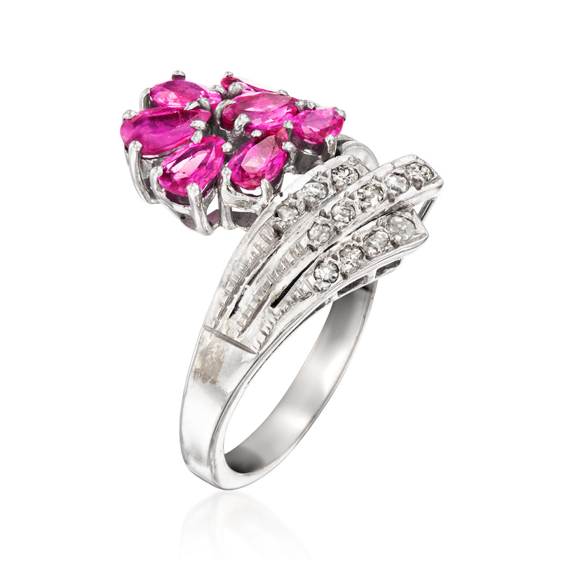 Side view of white gold bypass ring with pink rubies and diamond pave bands