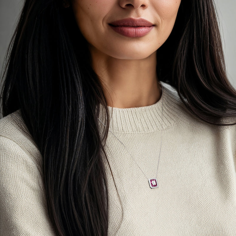 Square ruby pendant necklace worn on a collarbone-length chain