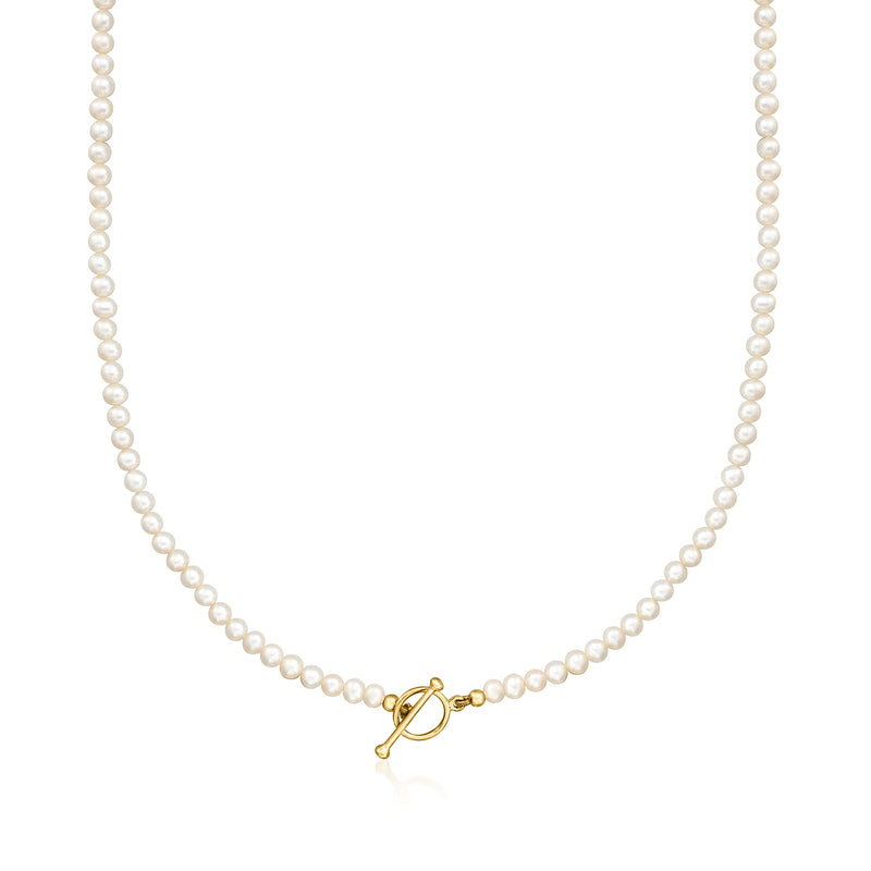 Cultured pearl toggle necklace with gold clasp on a strand of white pearls.