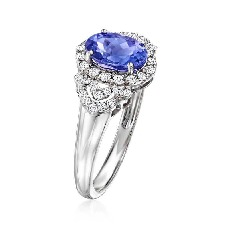 Platinum ring featuring an oval blue gemstone with diamond cluster halo and side stones.