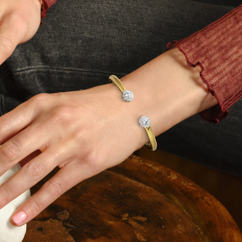 Gold-tone CZ ball cuff bracelet worn on wrist with two round stone accents