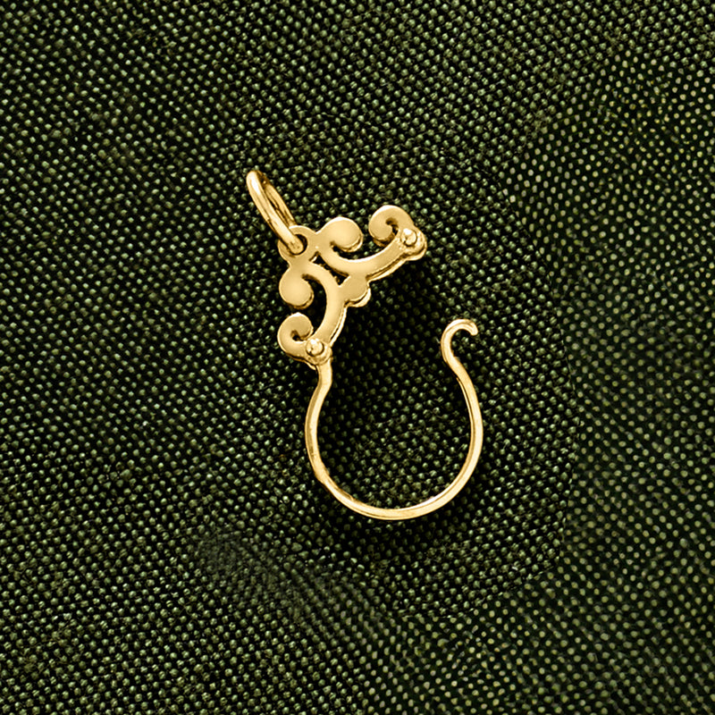 Yellow gold scrolled bail with ring loop charm holder pendant, close-up