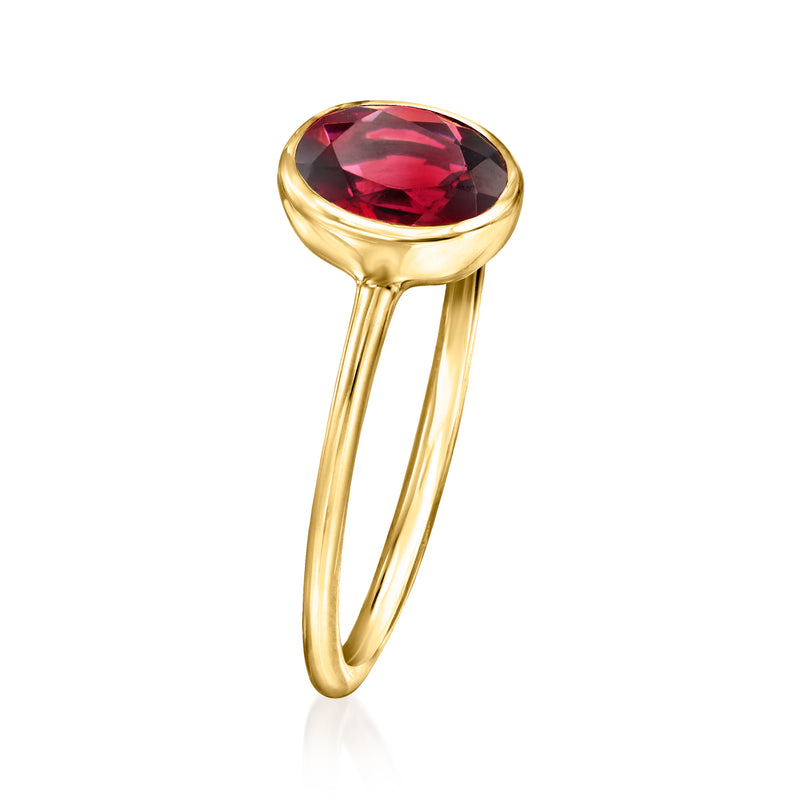 Oval bezel-set rhodolite garnet ring in 14kt yellow gold, side view of slender shank