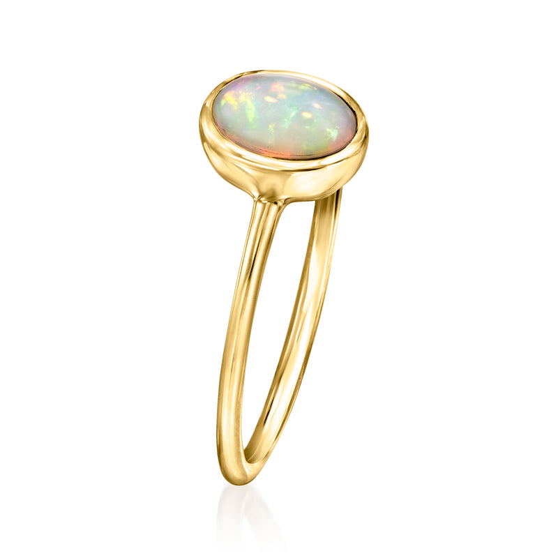 Oval opal bezel ring in 14kt yellow gold, tall setting with open band profile