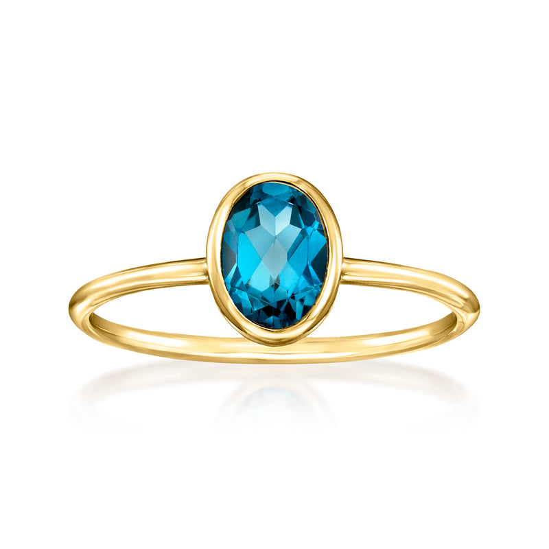 Oval blue topaz bezel ring in 14kt yellow gold with slim band