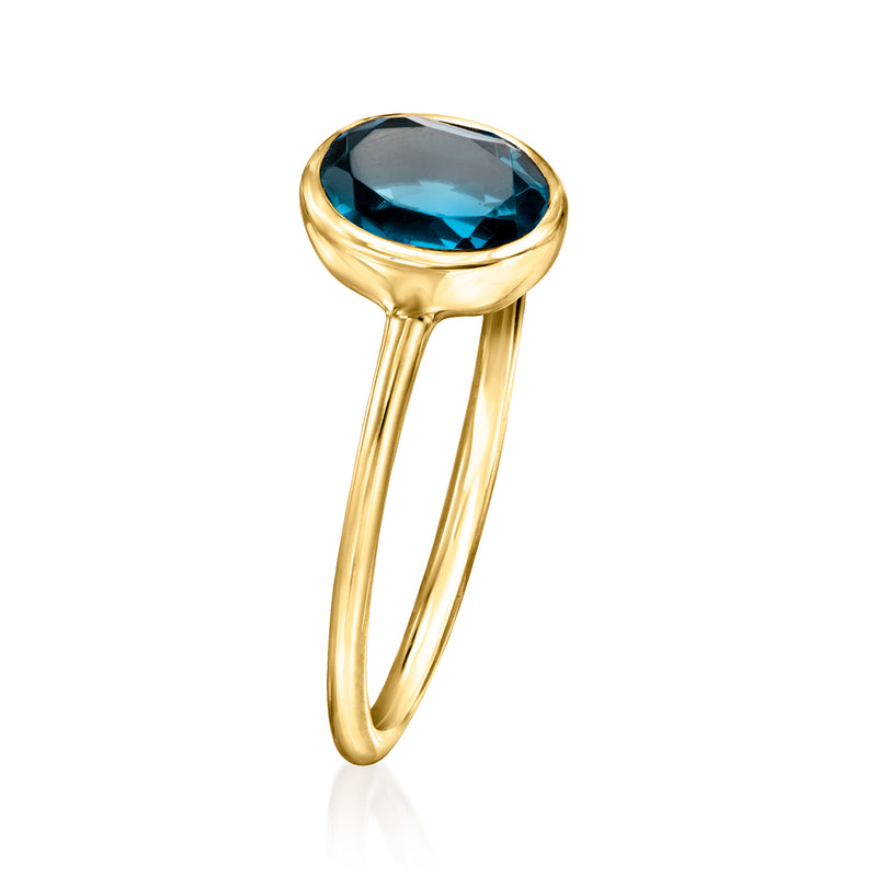 Oval blue topaz bezel ring in 14kt yellow gold, side profile view