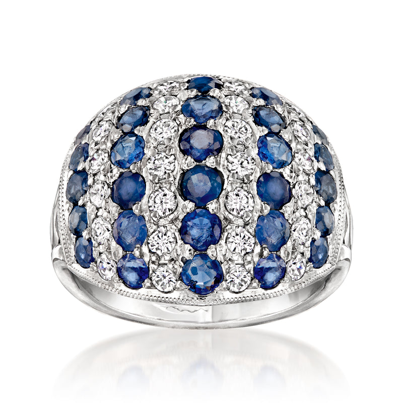Platinum dome ring with oval blue sapphires and round diamond accents, prong-set