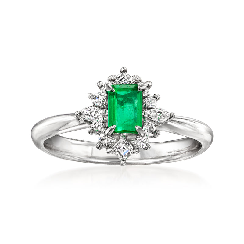 Platinum emerald-cut green gemstone ring with diamond halo and round side diamonds
