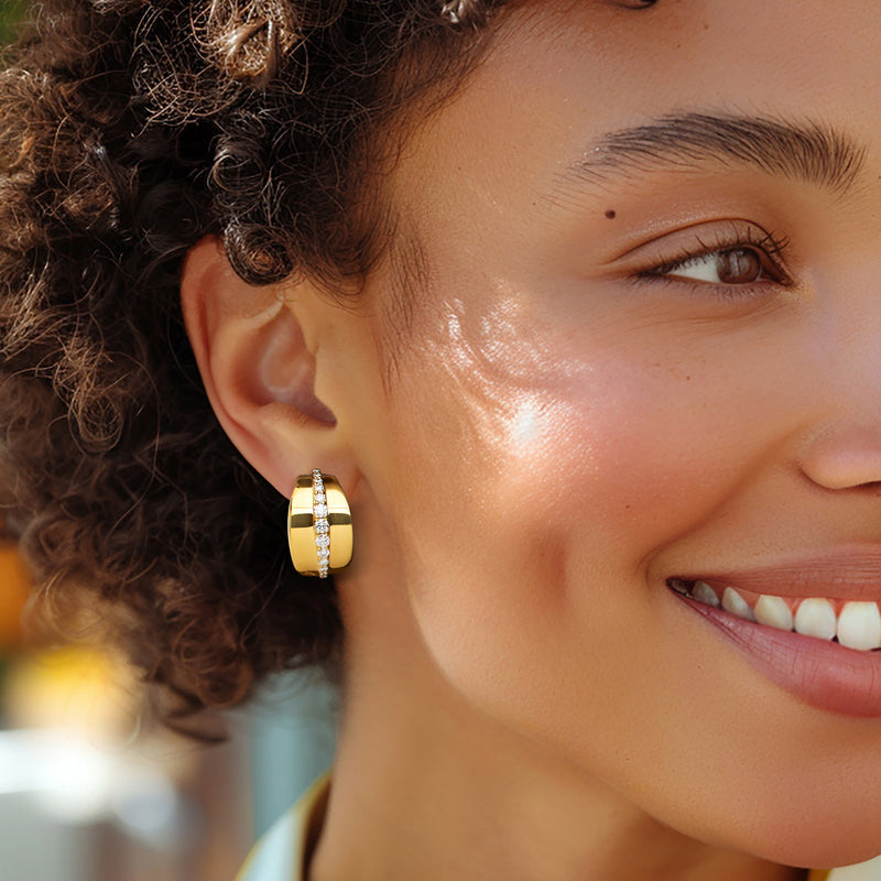 Gold hoop earrings with round diamonds in a striped arc