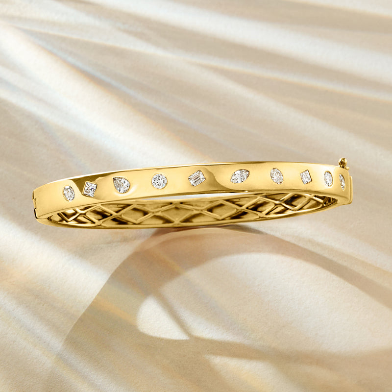 Gold diamond bangle bracelet with assorted shapes and etched lattice side pattern