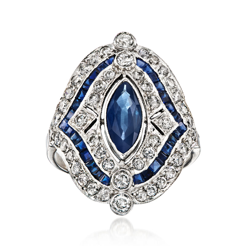 Vintage platinum ring with oval blue sapphire and diamond halo, scalloped prongs