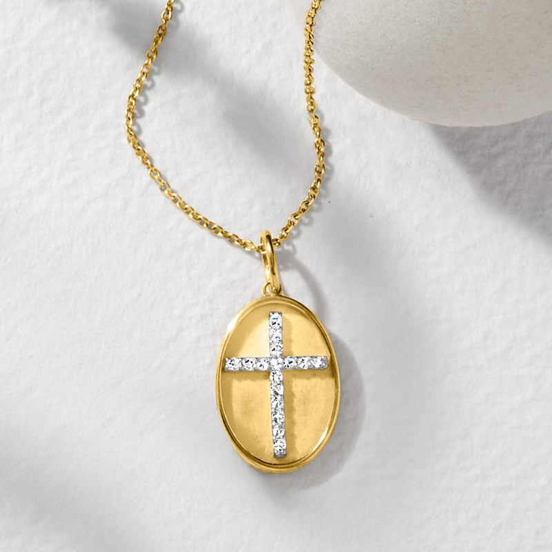 Gold oval pendant with diamond cross detail on a link chain