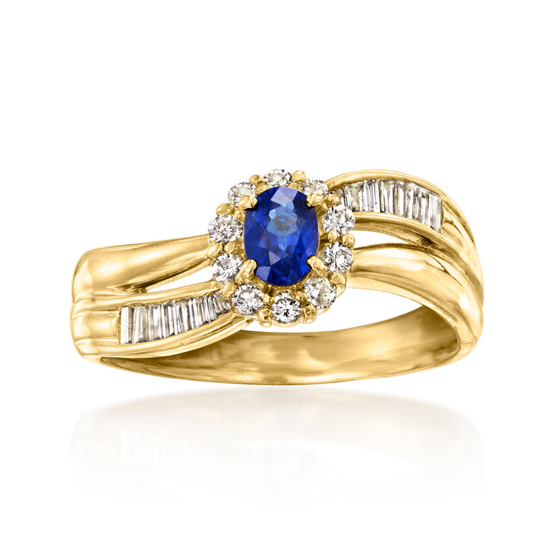 18kt yellow gold ring with oval blue sapphire center, diamond halo, and baguette sides
