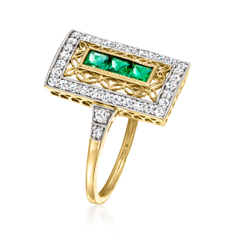 Yellow gold emerald ring angled view, emerald-green rectangular stone in diamond frame